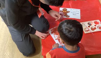 ESOL student and primary school aged child painting