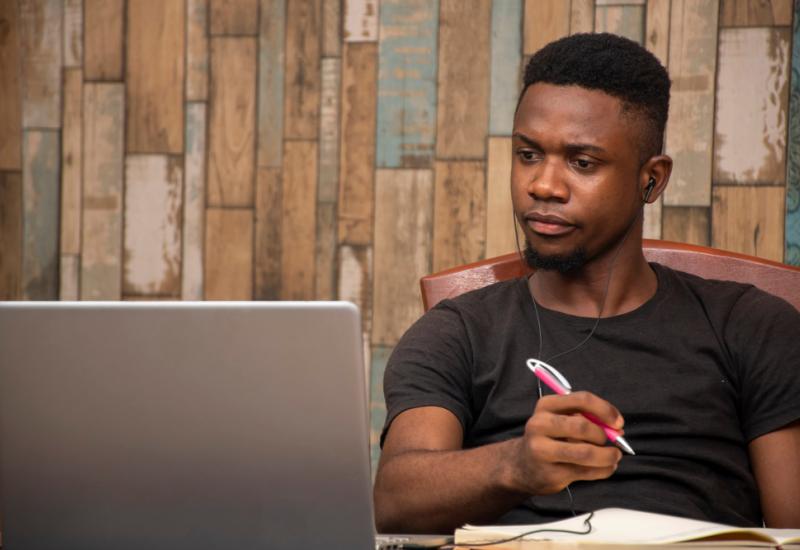 A young person working on a laptop