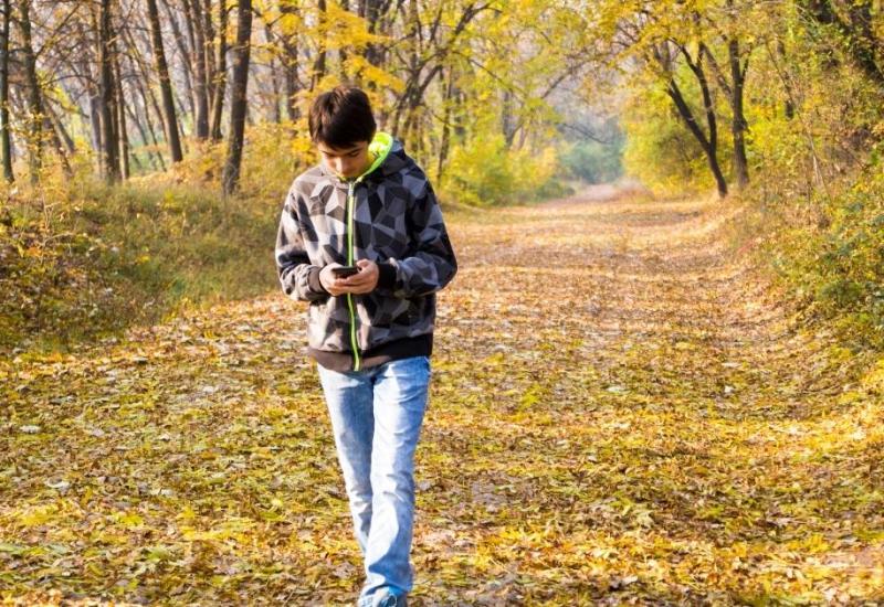 Young refugee walking down a country footpath