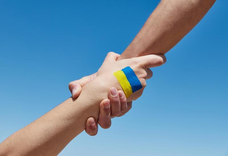 Helping hands with Ukraine flag