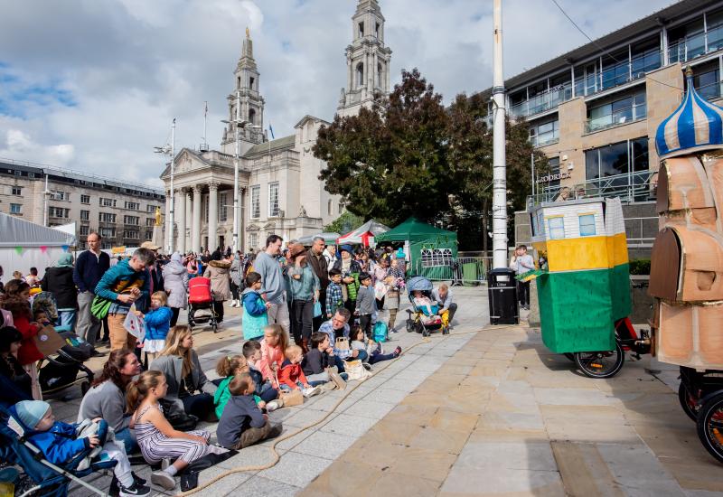 Families watching a puppet show at the Yorkshire Integration Festival 2022