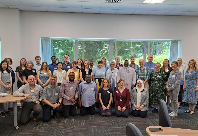 Group photo of about 37 people in a university teaching room.