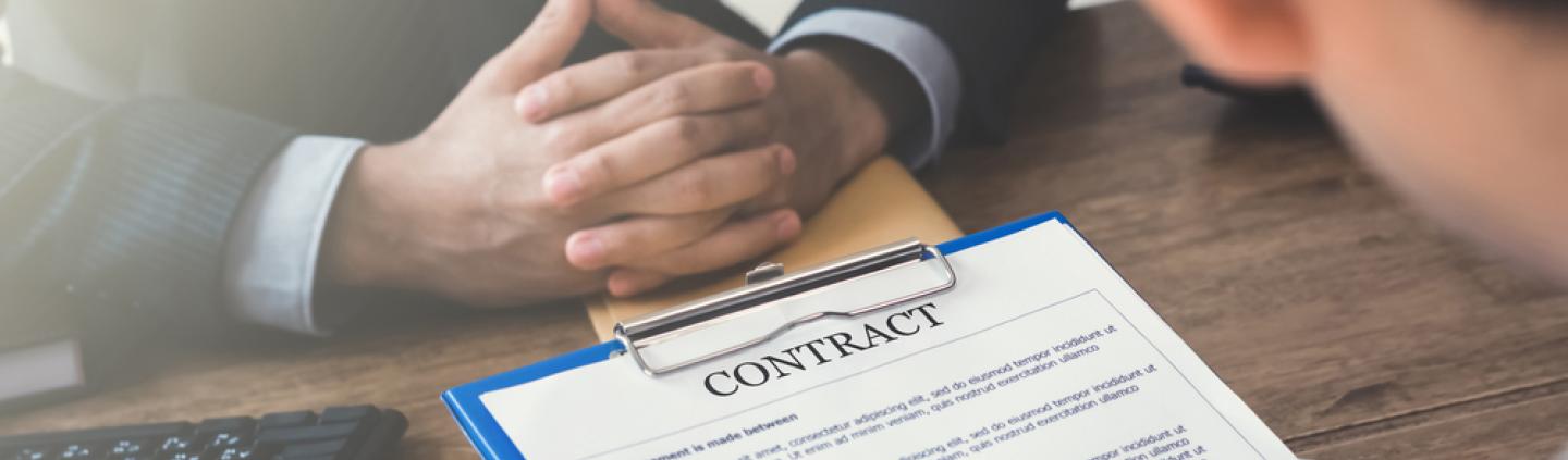 Two people discussing a contract of employment