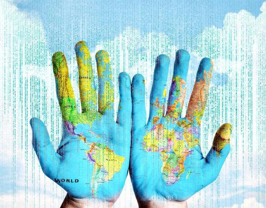 Map of the world projected onto two hands