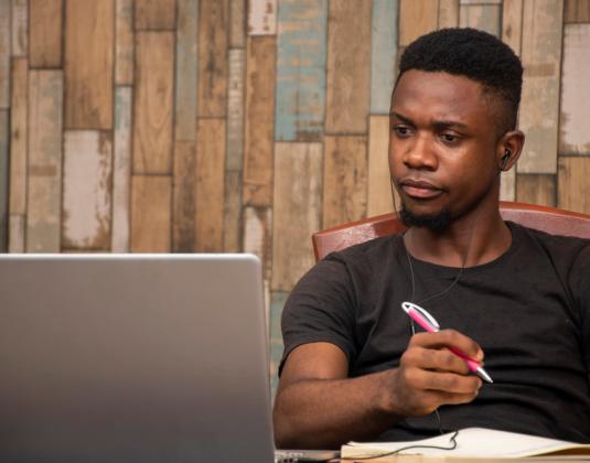 A young person working on a laptop