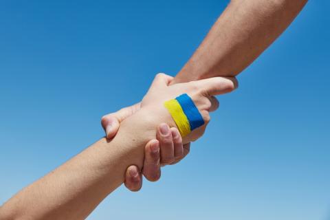 Helping hands with Ukraine flag