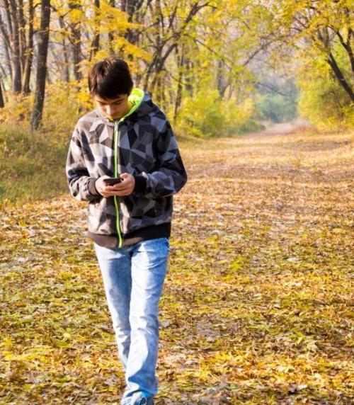 Young refugee walking down a country footpath